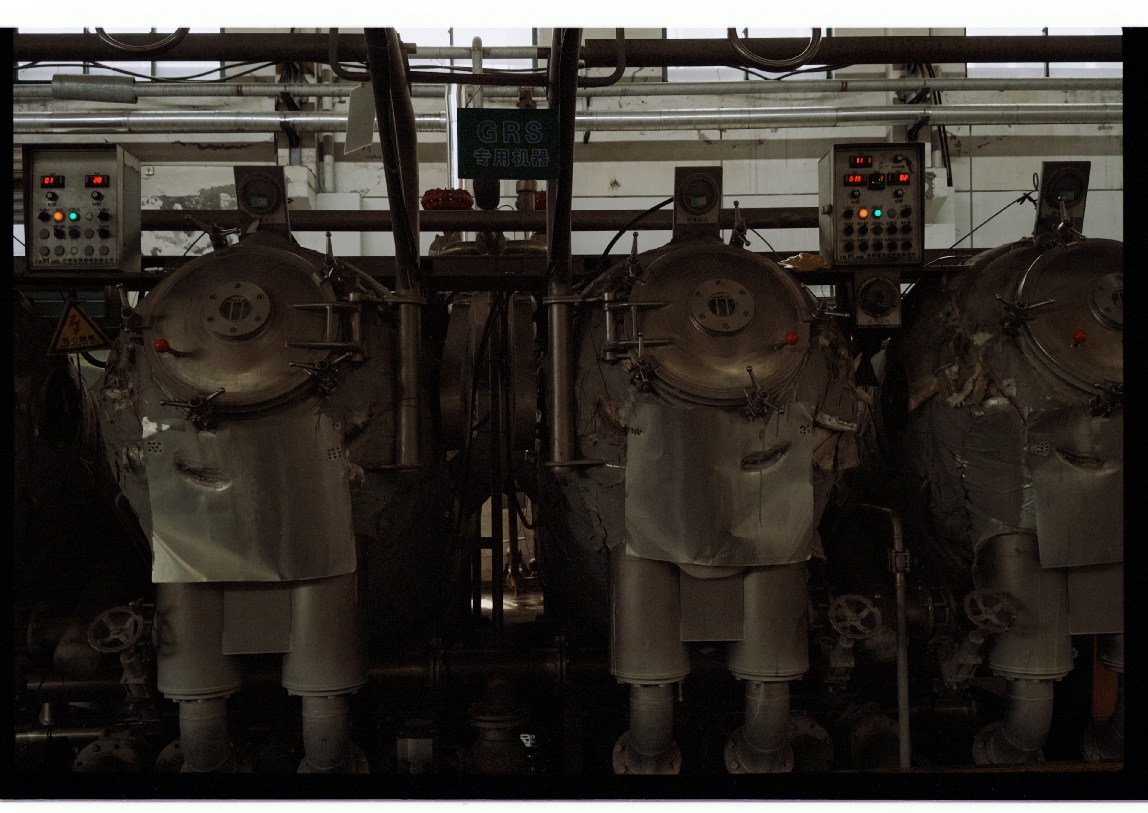 Dyeing machines photographed at a dyehouse, with a sign identifying equipment dedicated to GRS production.