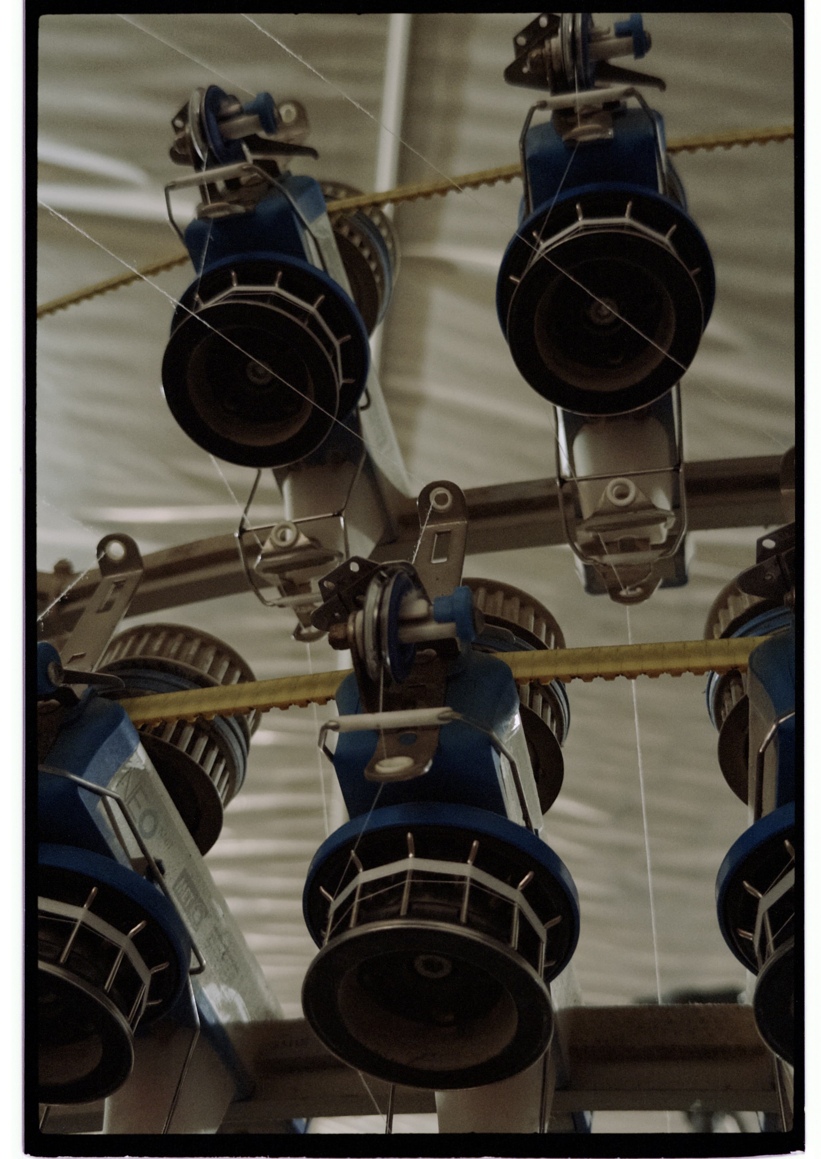 Yarn feeding components on a circular knitting machine, photographed during a mill visit.